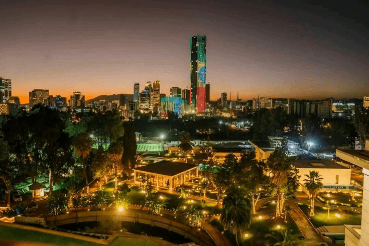 The capital's skyline beneath a burnt-orange sky.
