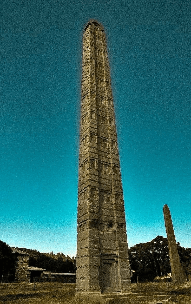 The Aksumite stele standing against a deep blue sky.